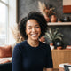 A diverse, smiling woman in a professional, modern setting representing a satisfied customer for a trust badge.